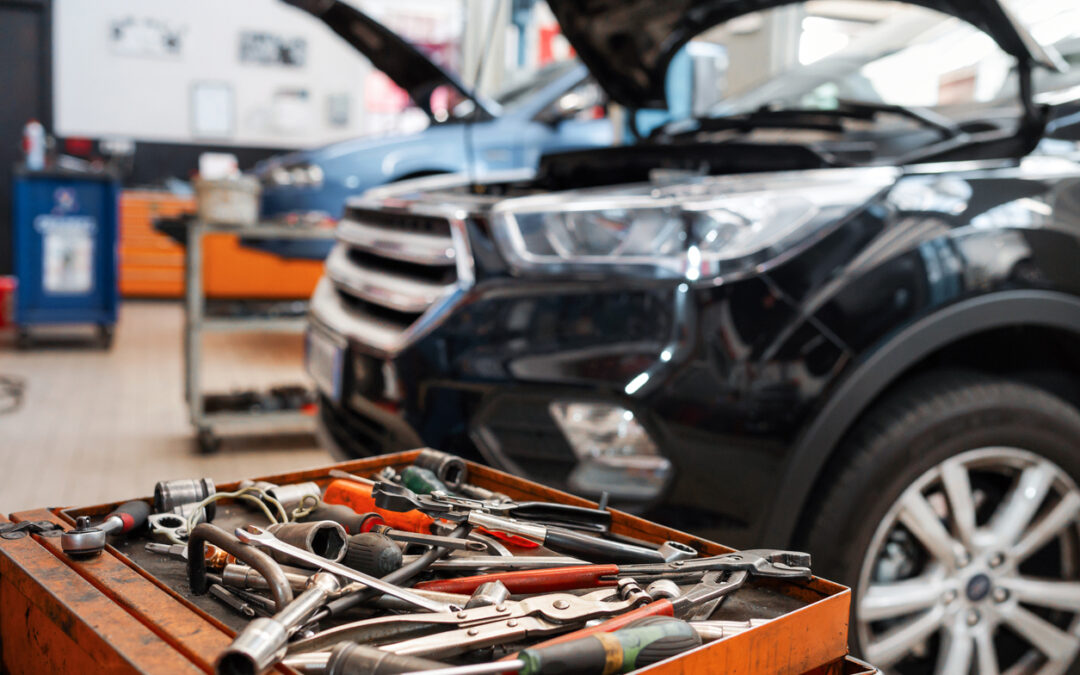 what insurance does an auto repair shop need | example of auto repair shop - tool tray with various tools with car in background